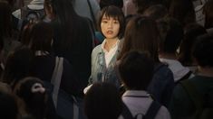 a group of people standing around each other with backpacks on their backs and one woman looking at the camera