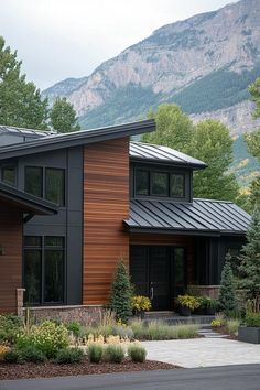 a modern house with mountains in the background