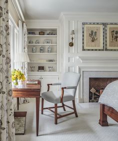 a white chair sitting next to a fireplace in a living room