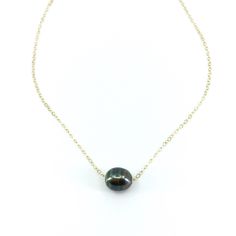 "The \"little black dress\" of necklaces. Our Floating Tahitian Pearl Necklace adds a timeless elegance to every outfit, the perfect accessory for every occasion. This necklace features one beautiful Tahitian Pearl on a delicate metal chain of your choice. In the drop down menu you may choose your preferred chain length as well as your preferred metal chain: Sterling Silver, 14k Gold Fill or 14k Rose Gold Fill. PLEASE NOTE: The genuine Tahitian Pearls will vary in shape, size and color and will Tahitian Pearls Jewelry, Tahitian Pearl Ring, Pearl Necklace Gold, Black Pearl Necklace, The Little Black Dress, Tahitian Pearl Necklace, Mermaid Jewelry, Floating Necklace, Pearl Bangle