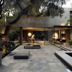 an outdoor living area with couches and tables