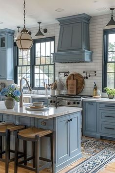 a kitchen with blue cabinets and an island