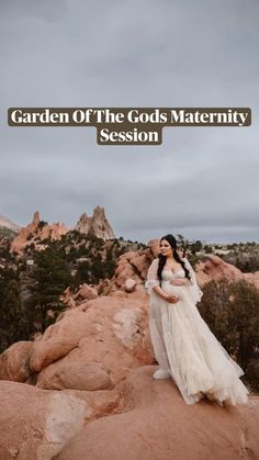 a woman in a white dress standing on top of a rock formation with the words garden of the gods maternity session