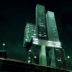 a very tall building sitting in the middle of a city at night