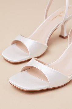 Whether you're the best-dressed guest or the bride-to-be, the Lulus Soline White Satin Slingback Low Heel Sandals are perfect for any special occasion! Sleek woven satin shapes these luxe heels that feature a trendy square footbed, a tapered toe strap, and a slender, adjustable slingback strap that secures with a gold buckle. A unique, sculpted heel completes the simple and sensational design. 2. 75" sculpted heel. Cushioned insole. Felted rubber sole has nonskid markings. Man made materials. Imported. Lulus | Soline White Satin Slingback Low Heel Sandal Heels | Size 5.5. White Satin Heels, Wedding Bride Shoes, Bridal Heels, Low Heel Sandals, Size 11 Heels, Sandal Heels, Bride Shoes, White Bridal, Heel Sandal