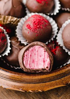 there are chocolates with pink frosting in the bowl