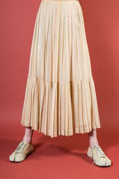 "Description: 1970s Long Gauze Prairie Pale Stripe Maxi Skirt Features:  Full pleated skirt, full length, lovely cotton blend gauze, tiered bottom ruffle hem. Lined with cotton. Era: 1970s Label: Country Set, Union label stamp, made in USA  Estimated Fit: XS-S (see below)  Fabric: 65% cotton, 35% poly  Condition: Very Good vintage condition, some minor spots not significant, recently dry cleaned. Label indicates machine washable.  Measurements:   WAIST (flat doubled): 26.5\" at high/natural waist HIPS (flat doubled): 36\" open full skirt (see below) LENGTH: 39.5\"  We measure all garments flat (and we double where relevant). We recommend comparing measurements to garments you own and love to ensure a piece is right for you. We consider condition when pricing all garments while acknowledgin Beige Tiered Pleated Skirt For Spring, Spring Cotton Skirt With Accordion Pleats, Summer Cotton Skirt With Accordion Pleats, Spring Pleated Tiered Skirt With Ruffles, Beige Pleated Tiered Skirt Bottoms, Beige Ruffled Maxi Skirt For Spring, Pleated Tiered Maxi Skirt, Retro Flared Maxi Skirt For Spring, Voluminous Skirt With Accordion Pleats For Spring