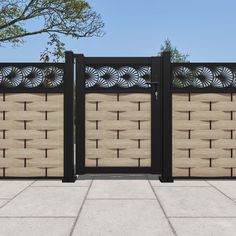 a wooden fence with decorative designs on the top and bottom panels, along with concrete flooring