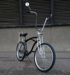 a black and white bicycle parked on the street