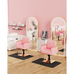 two pink chairs sitting in front of mirrors on top of a hard wood floor next to each other