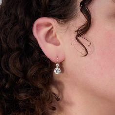 These captivating diamond earrings are both beautiful and timeless in style. The earrings are each accented with one (1) old European cut diamond set into an eight-prong platinum setting and one (1) old European cut diamond set into a four-prong platinum setting. The earrings measure 21.9mm X 9.0mm. They are platinum topped 18K yellow gold and finished with 14K yellow gold lever backs. Antique Yellow Gold Diamond Earrings, Antique Yellow Gold Diamond Earrings With Accents, Luxury Antique Diamond Earrings With Single Cut Diamonds, Victorian Yellow Gold Diamond Earrings With Accents, Victorian Yellow Gold Drop Diamond Earrings, Diamond Drop Earrings, Diamond Drops, European Cut Diamonds, One 1