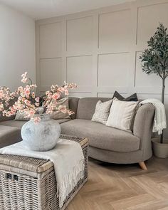 a living room filled with furniture and a large vase on top of a coffee table