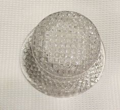 a clear glass dish sitting on top of a white table