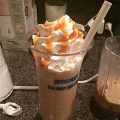 an iced coffee drink with marshmallows and whipped cream in a plastic cup