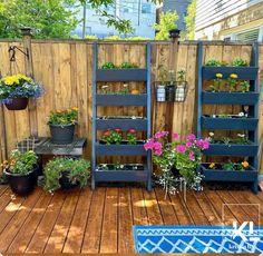 a wooden deck with potted plants on it