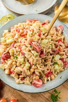 pasta salad with tomatoes and cucumbers in a bowl