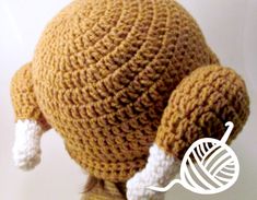 a crocheted brown and white stuffed animal with its head turned to the side