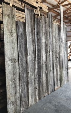 an old wooden fence is being used as a room divider