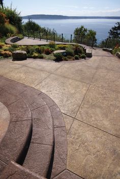 an outdoor patio with steps leading to the water