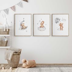 three framed pictures hang on the wall above a teddy bear in a crib,