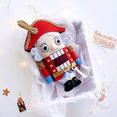 an ornament in the shape of a nutcracker is sitting on a piece of paper