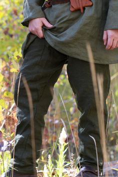 Linen Viking Age Pants in Dark green These pants come with a Blue drawstring that can be switched out. After years of perfecting patterns and materials our pants we are finally in production and available for preorder. Now these pants have been tricky and time-consuming. Through my reenactment journey I've gone through quite a few pairs, there's only so many times you can patch pants before you decide: enough is enough - we must make our own. Plenty of gusset room but no unnecessary seams that a Green Parachute Pants With Elastic Waistband And Tapered Leg, Green Parachute Pants With Elastic Waistband, Green Linen Harem Pants With Elastic Waistband, Green Bottoms With Elastic Waistband For Outdoor, Green Linen Bottoms With Side Pockets, Green Outdoor Bottoms With Elastic Waistband, Olive Trousers With Side Pockets, Olive Pants With Side Pockets, Olive Linen Bottoms With Pockets