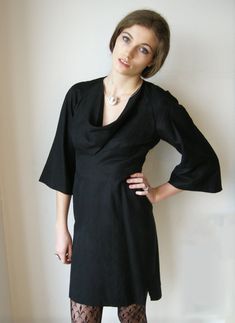 "Black silk and linen cowl neck dress has diamond shaped insets at the sides and 3/4 bell sleeves 2 small side slits at the side seams measure 3 3/4\" The body is a blend of silk, rayon and linen and the lining is 100 % silk which will make you feel beautiful inside the dress- The perfect dress to wear to work and then cocktails and dinner. Black invisible zipper at center back. Dry clean only Available in sizes: 2,4,6 and 8 size: 2 bust 34\" waist 26.5\" hip 33\" length 36\" sleeve 25\" size: 4 bust 34\" waist 28.5\" hip 36\" sleeve 25\" length 36\" size: 6 bust 36\" waist 29.5\" hip 38\" sleeve 25\" length 36\" size: 8 bust 38\" waist 31\" hip 39.5\" sleeve 25\" length 36\" like astridland on facebook: http://www.facebook.com/astridland follow me on twitter: http://twitter.com/astridland Elegant Linen Dress With 3/4 Sleeves, Fitted Silk Dress With 3/4 Sleeves, Chic Fitted Linen Dress For Evening, Fitted Silk Dress With Cowl Neck, Elegant Asymmetrical Linen Dress, Elegant Fitted V-neck Linen Dress, Fitted Cowl Neck Dress For Formal Occasions, Formal Fitted Cowl Neck Dress, Fitted Linen Evening Dress