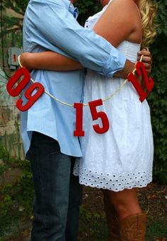 a man and woman standing next to each other with the number fifteen on it's string