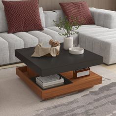 a living room with a couch, coffee table and books on the shelf in front of it