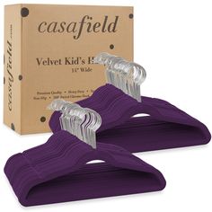 purple velvet kids's hangers in front of a cardboard box