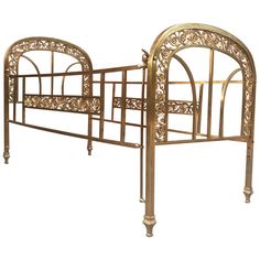 a gold metal bed frame with intricate carvings