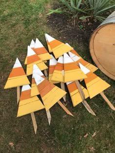 a bunch of orange and white pieces of wood sitting on the ground