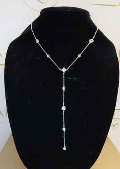 Bezel set CZ Crystals on a rhodium plated 16" chain with 2" extender and 5" Lariat. Formal Crystal Lariat Jewelry, Backdrop Necklace With Long Drop And Adjustable Chain, Silver Lariat Diamond Necklace, Cubic Zirconia Dangle Jewelry With Adjustable Chain, Adjustable Silver Lariat Necklace With Long Drop, Drop Necklace With Adjustable Chain And Cubic Zirconia, Formal Lariat Jewelry With Cubic Zirconia, Formal Cubic Zirconia Lariat Jewelry, Sparkling Long Drop Jewelry