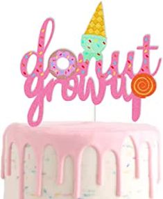 a pink cake topped with a donut and the words do it yourself on top