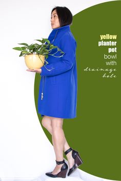 a woman in a blue coat holding a potted plant with the words below it