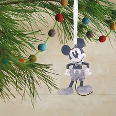 a mickey mouse ornament hanging from a christmas tree