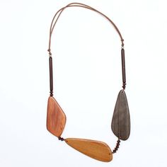 Three geometric wood beads make up this neutral palette statement necklace. The large wood beads are accented with small beads between each and finished off with bar beads topped with a silver ball bead. The necklace hangs on an adjustable brown wax cord. The neutral palette makes this necklace easy to pair with any outfit. Adjustable length: 24″-28″ Largest bead: 3.5″L x 1″ W Brown Mustard, Small Beads, Wood Necklace, Beaded Top, Neutral Palette, Fantastic Art, How To Make Beads, Wood Beads, Handcrafted Jewelry