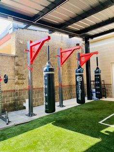 an outdoor gym area with punching bags