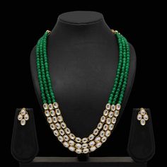 Enhance your outfits with our dignified Ruhi kundan necklace set made with kundan, green beads, and gold plating. This necklace and earrings jewelry set has sophisticated appeal that's perfect for all occasions. Specifications Materials used: kundan, green beads, gold plating Length: 46 cm (necklace), 2.5 cm (earrings) Weight: 120 grams Sold Out! At Romikas, we pride ourselves on the craftsmanship and high quality of our jewelry, designed to enhance your natural beauty. Please contact us with an Green Meenakari Pearl Necklace For Celebration, Green Kundan Necklace With Cutdana For Celebration, Green Kundan Necklace With Cutdana For Diwali, Green Kundan Necklace For Diwali Celebration, Green Kundan Cutdana Necklace For Diwali, Green Bollywood Kundan Necklace For Celebrations, Festive Green Kundan Necklace For Celebration, Festive Green Kundan Necklace, Festive Green Pearl Necklace In Temple Jewelry Style