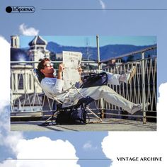 a man sitting in a chair on top of a roof reading a newspaper while wearing sunglasses