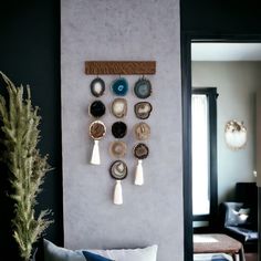 a living room with black walls and blue accents on the wall, along with white pillows