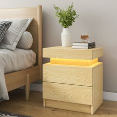 a bed room with a neatly made bed and a night stand next to the bed