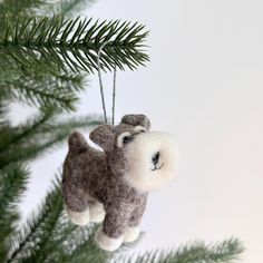 a stuffed animal ornament hanging from a christmas tree