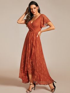 a woman wearing an orange lace dress