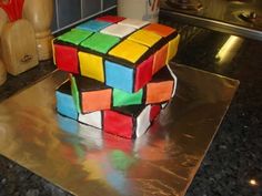 there is a cake made to look like a rubik cube on the counter top