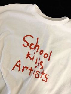 a white t - shirt with red writing that says school kills artists on the front