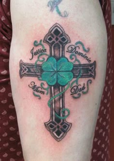 a cross with four leaf clovers on it