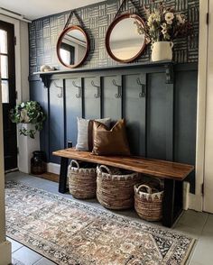 a bench with baskets and mirrors on the wall