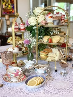 a table topped with lots of different types of food and desserts on top of it