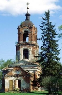 an old, run down church with a steeple and cross on it's roof